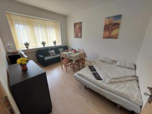 a living room with a bed and a table at Apartmán v centre Bratislavy in Bratislava