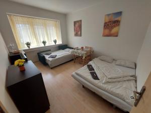 A bed or beds in a room at Apartman Michaela