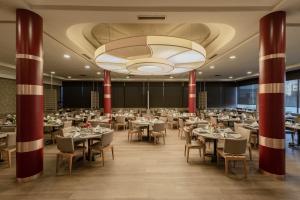 a banquet hall with tables and chairs and a chandelier at Le Palace d'Anfa in Casablanca