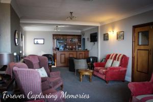 uma sala de estar com sofás e cadeiras em Morningside Hotel em Whitby