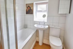 a bathroom with a tub and a toilet and a sink at Host & Stay - Elliott Terrace in Wark