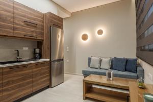 a living room with a couch and a kitchen at Athena Apartment in Heraklio