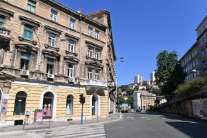 an old building on a street in a city at Tyson Apartman Rijeka in Rijeka