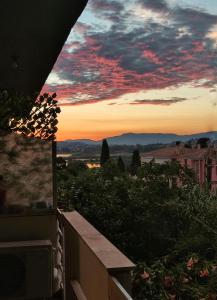 a view of the sunset from the balcony of a house at Beautifull And Airy Appartment Corfu Town in Kanoni