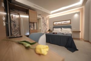 a bedroom with a bed and a table with a table sidx sidx sidx at ELISEO PALACE TROPEA in Tropea