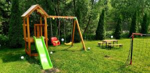 a playground with a swing set and a table at Casa langa rau in Bran