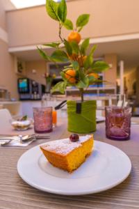 a piece of cake on a white plate on a table at ELISEO PALACE TROPEA in Tropea