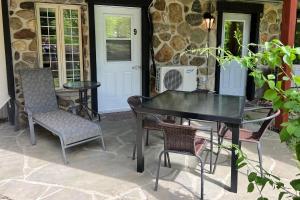 a black table and chairs on a patio at L'escale d'Orford in Orford