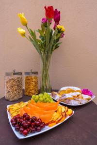 a table with two plates of food and a vase with flowers at ELISEO PALACE TROPEA in Tropea