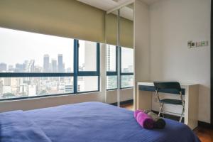 a bedroom with a bed and a desk and a chair at Casa Residency Apartment in Kuala Lumpur +67 photos