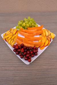 a plate of fruits and vegetables on a table at ELISEO PALACE TROPEA in Tropea
