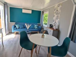 a living room with a table and chairs at Domaine bulle étoilée in Rouilly-Sacey