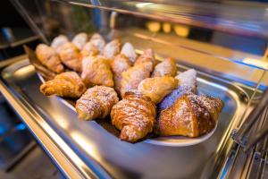 a plate of pastries in a display case at ELISEO PALACE TROPEA in Tropea
