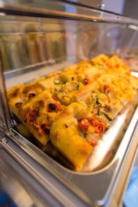 a glass display case with a bunch of pizza at ELISEO PALACE TROPEA in Tropea
