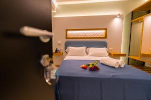a bedroom with a blue bed with flowers on it at ELISEO PALACE TROPEA in Tropea
