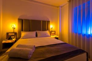 a bedroom with a large bed with two towels on it at ELISEO PALACE TROPEA in Tropea