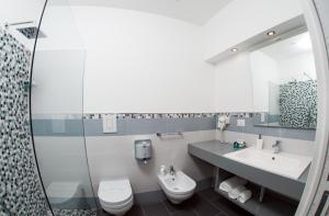 a bathroom with a sink and a toilet and a shower at B&B Diana in Piazza Armerina