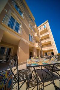 a table and chairs in front of a building at ELISEO PALACE TROPEA in Tropea