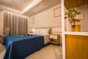 a hotel room with a bed with a blue table at ELISEO PALACE TROPEA in Tropea