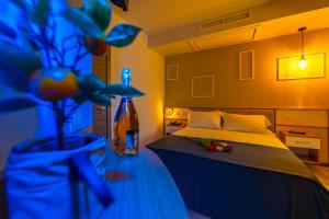 a bedroom with a bed and a vase with flowers at ELISEO PALACE TROPEA in Tropea