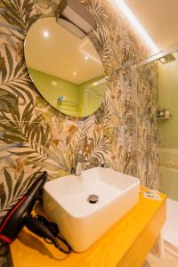 a bathroom with a white sink and a mirror at ELISEO PALACE TROPEA in Tropea