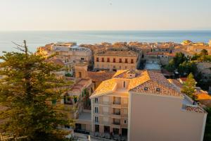 a cityscape of a city with buildings and the ocean at ELISEO PALACE TROPEA in Tropea