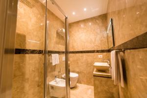 a bathroom with a shower and a toilet and a sink at ELISEO PALACE TROPEA in Tropea