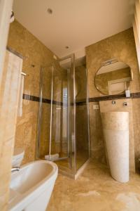 a bathroom with a shower and a toilet and a sink at ELISEO PALACE TROPEA in Tropea