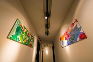 two paintings hanging on the walls of a room at ELISEO PALACE TROPEA in Tropea
