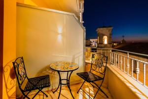 a balcony with a table and chairs on a balcony at ELISEO PALACE TROPEA in Tropea