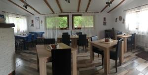 a dining room with tables and chairs and windows at Casa langa rau in Bran