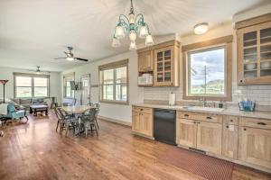 a kitchen and dining room with a table and chairs at Idyllic Gem Screened Porch, half Mi to River! in Thermopolis