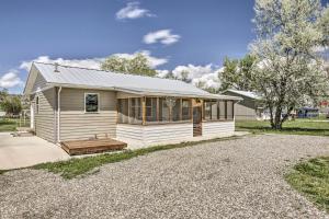 a white house with a porch and a driveway at Idyllic Gem Screened Porch, half Mi to River! in Thermopolis