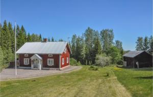 an old red barn and a barn house at Cozy Home In Lesjfors With Kitchen in Lesjöfors