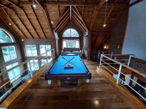 a pool table in the middle of a room at Hosteria & Spa Las Walkirias in San Martín de los Andes
