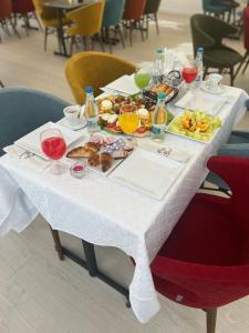 a white table with food and drinks on it at Casa ON in Mamaia Nord