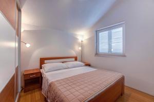 a small bedroom with a bed and a window at ERE Apartment in Srima +26 photos
