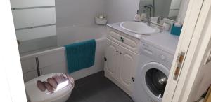 a bathroom with a washing machine and a sink at villa Paty in Bonifacio
