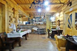 a dining room with two tables and a fireplace at Góralski Pałacyk in Biały Dunajec