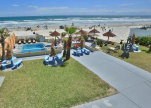 an aerial view of a resort with a beach and a pool at Daytona Dream Inn By AmeriVu in Daytona Beach