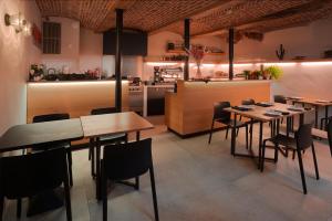 a restaurant with tables and chairs and a kitchen at Hotel Neuvice in Liège
