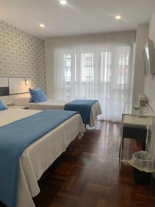 Postel nebo postele na pokoji v ubytování Hostal San Fernando