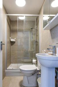 a bathroom with a shower and a toilet and a sink at Entire 1 bed apt in the centre of Stockport in Stockport