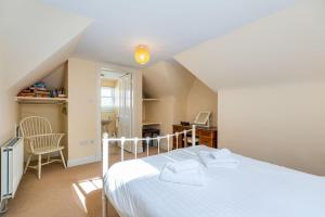 a bedroom with a bed and a desk and a chair at Royal Gardens Apartments in Stirling
