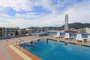 a swimming pool on the roof of a building at The Crystal Beach Hotel in Patong Beach