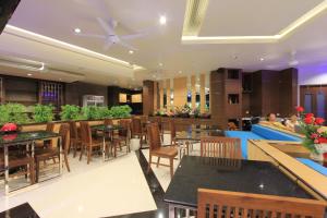 
a kitchen filled with tables, chairs, and tables at The Crystal Beach Hotel in Patong Beach
