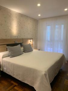 Postel nebo postele na pokoji v ubytování Hostal San Fernando