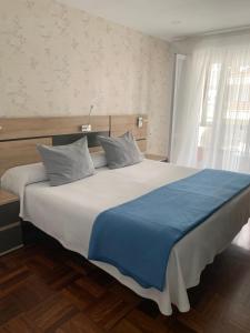 Postel nebo postele na pokoji v ubytování Hostal San Fernando