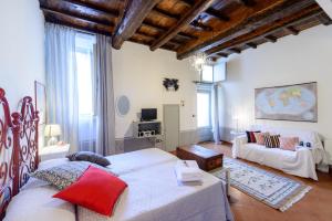 a bedroom with a large bed and a couch at B&B La Polinnia in Bagnoregio