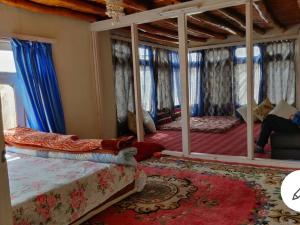 a bedroom with a bed and a large mirror at amir homestay in Leh